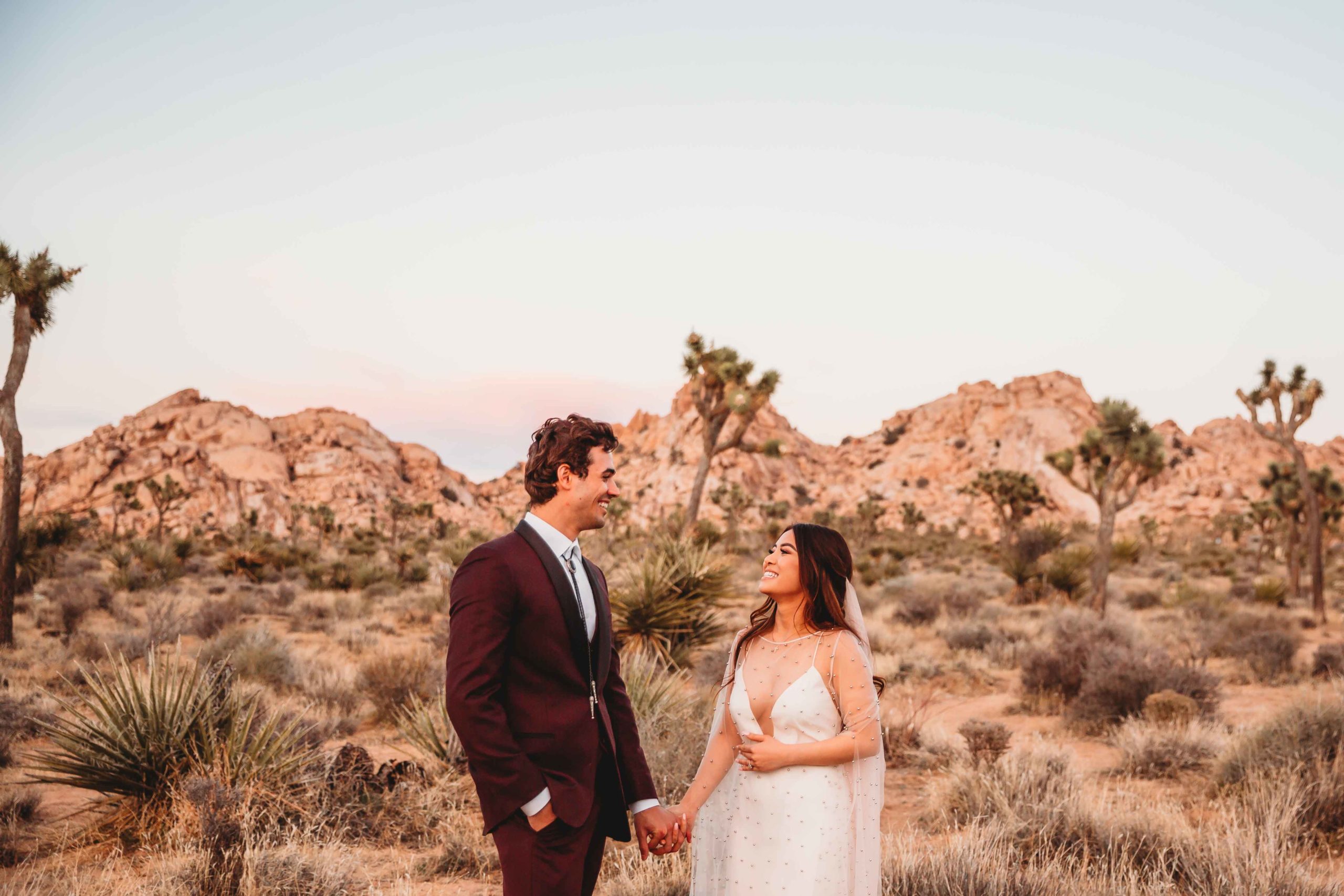 couple in desert holding hands after elopement session in joshua tree